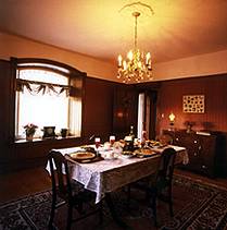 The formal dining room features two windows that look out onto the valley.