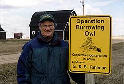Grant Fahlman beside the sign presented to him by Prince Philip in 1987.